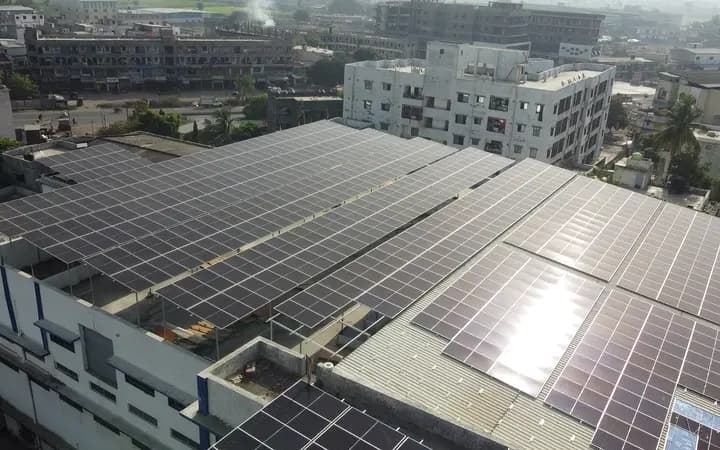 Aerial view of a commercial roof covered edge to edge with solar panels
