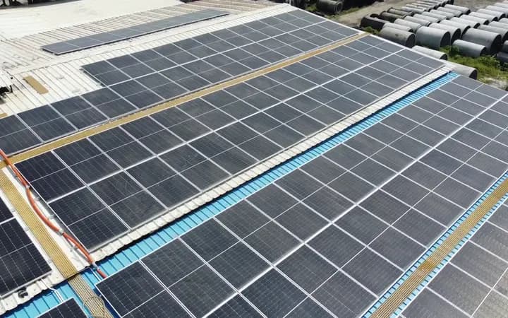 Low aerial pass along panel rows, walkways and cable runs